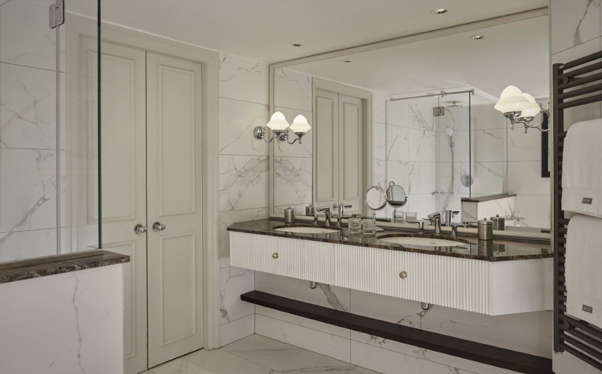 Double vanity bathroom with white marble in The College Green Hotel Dublin